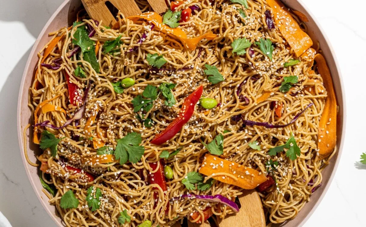 Colorful rainbow peanut noodles with various toppings