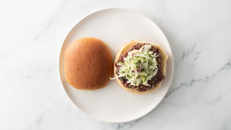 Open faced pork burger with slaw on plate