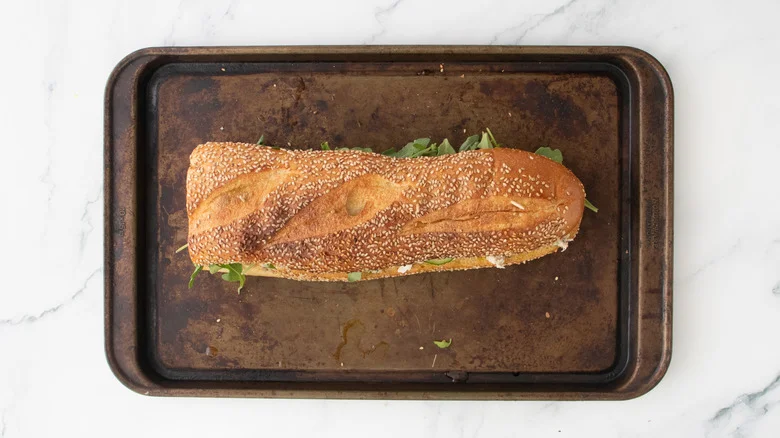 A large tuna salad sandwich secured with toothpicks.