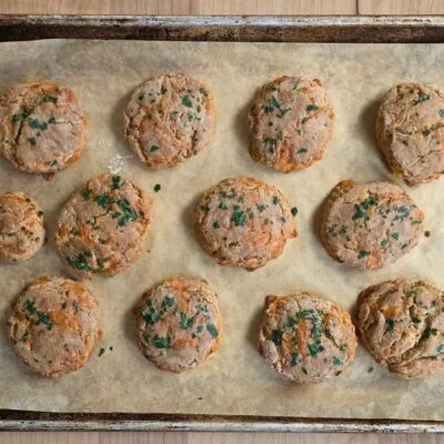 Red wheat cheddar bay biscuits on baking sheet