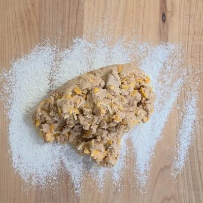 Red wheat cheddar bay biscuit dough on flour